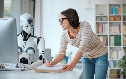 Woman and AI robot working together in the office, automation and technology concept (1).jpeg