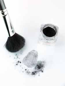 Aerial perspective view of a fingerprint revealed by printing dust, with a brush and printing dust recipient (1).jpeg